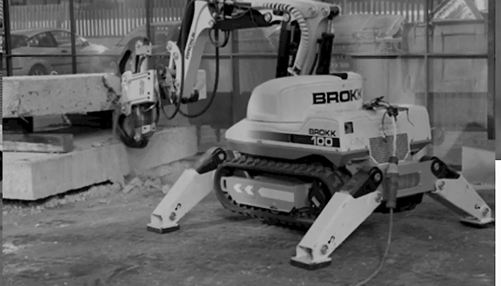 Robotic demolition machine Brokk 100 cutting concrete block in construction site, showcasing advanced drilling technology by National Drilling Services.