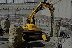 Brokk demolition robot operating on concrete pillars in a construction site, showcasing precision and safety in demolition services by National Drilling Services.