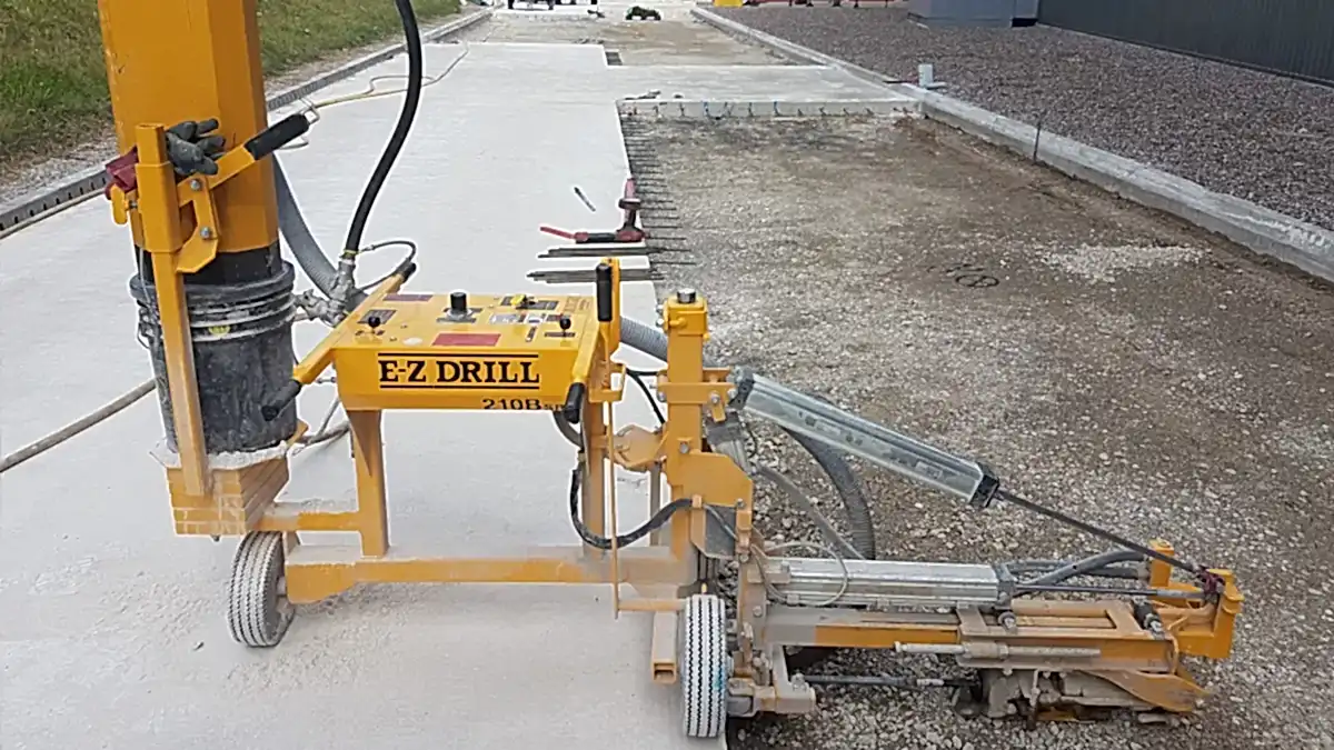E-Z Drill 210B drilling machine on construction site for concrete sawing and drilling services by National Drilling Services, showcasing advanced equipment for industrial applications.