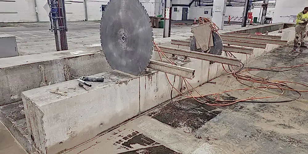 Concrete cutting setup with track saws, showcasing precision diamond core drilling equipment and workspace environment.