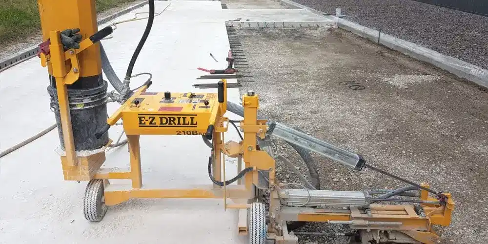 E-Z Drill 210B drilling rig on construction site, showcasing precision diamond core drilling equipment for various materials.
